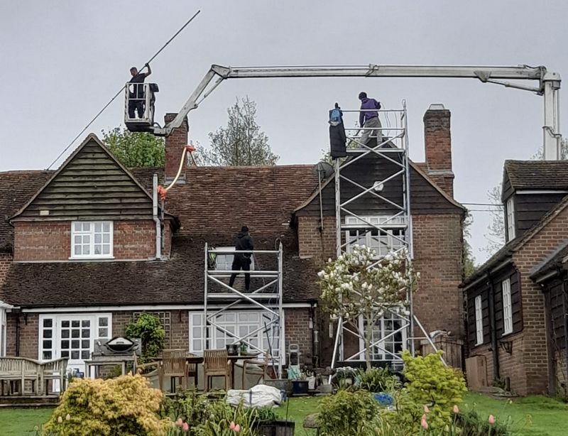 The Roof Moss Cleaners using cherry picker and scaffolding to clean roof safely and professionally in Buckingham, Buckinghamshire