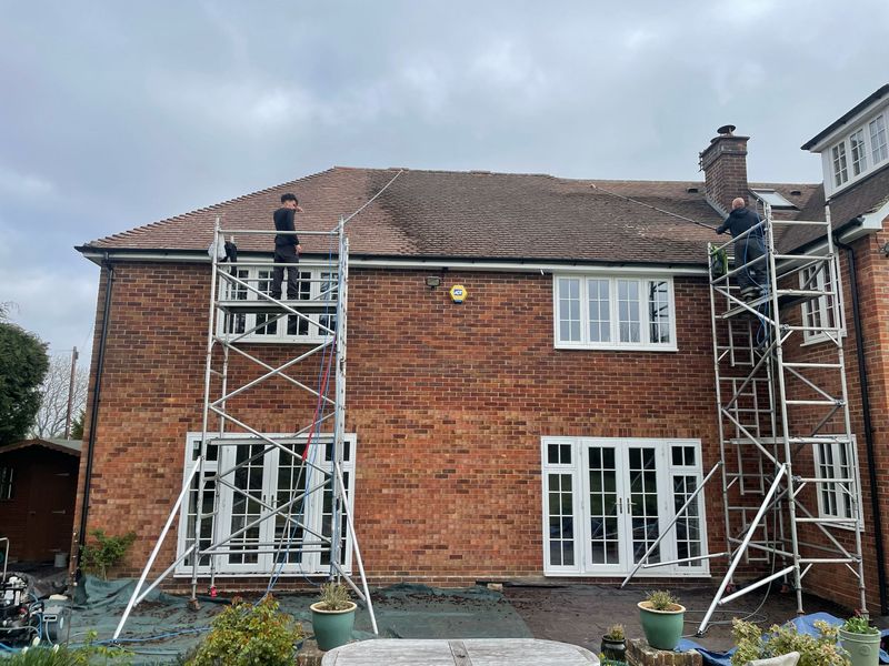 Roof cleaning carried out safely from scaffold towers by The Roof Moss Cleaners in Buckingham